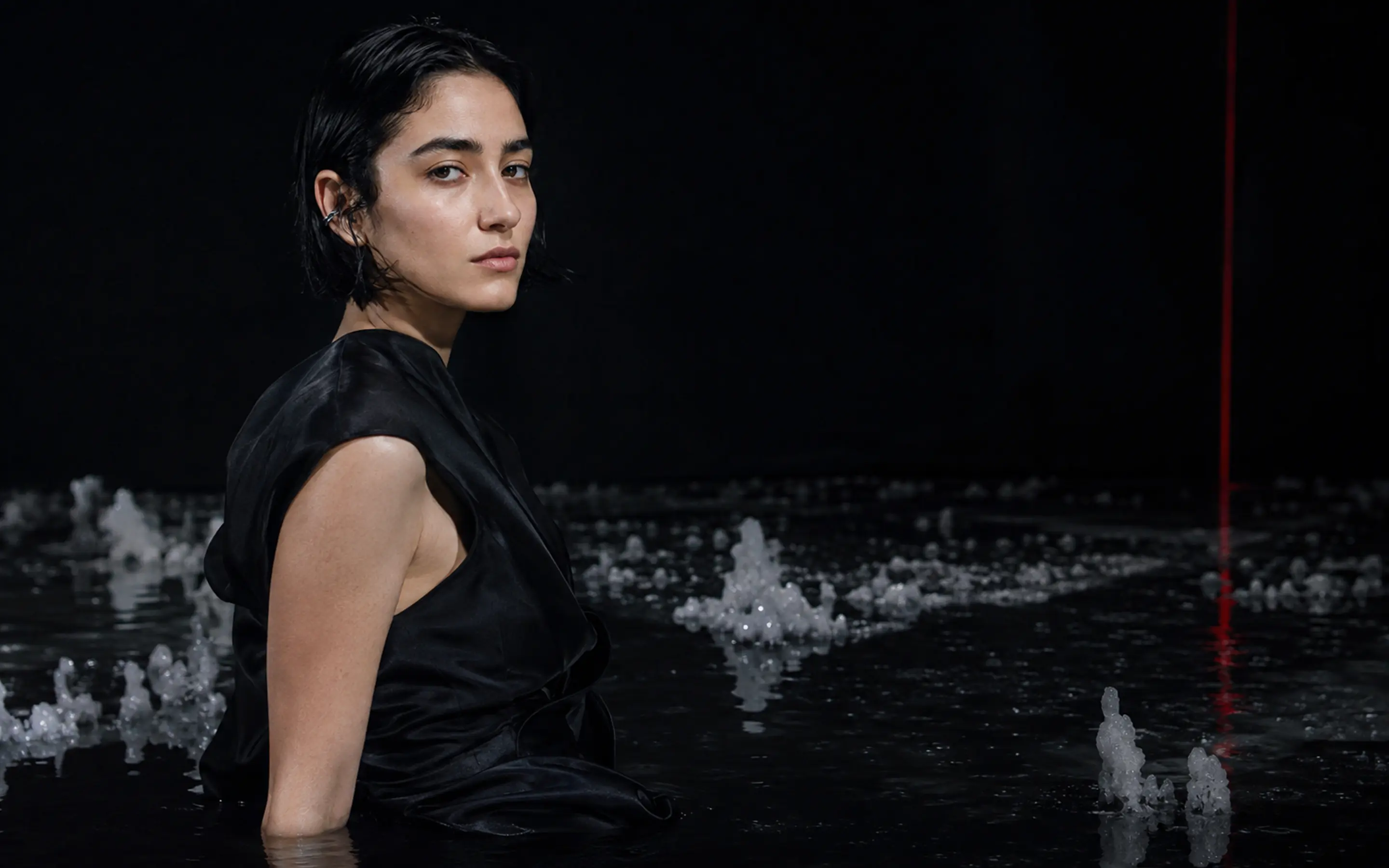 Mira Silt in the dark-water visual world of her fictional debut album Salt Memory.
